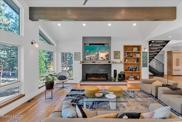 a living room with fireplace furniture and a flat screen tv