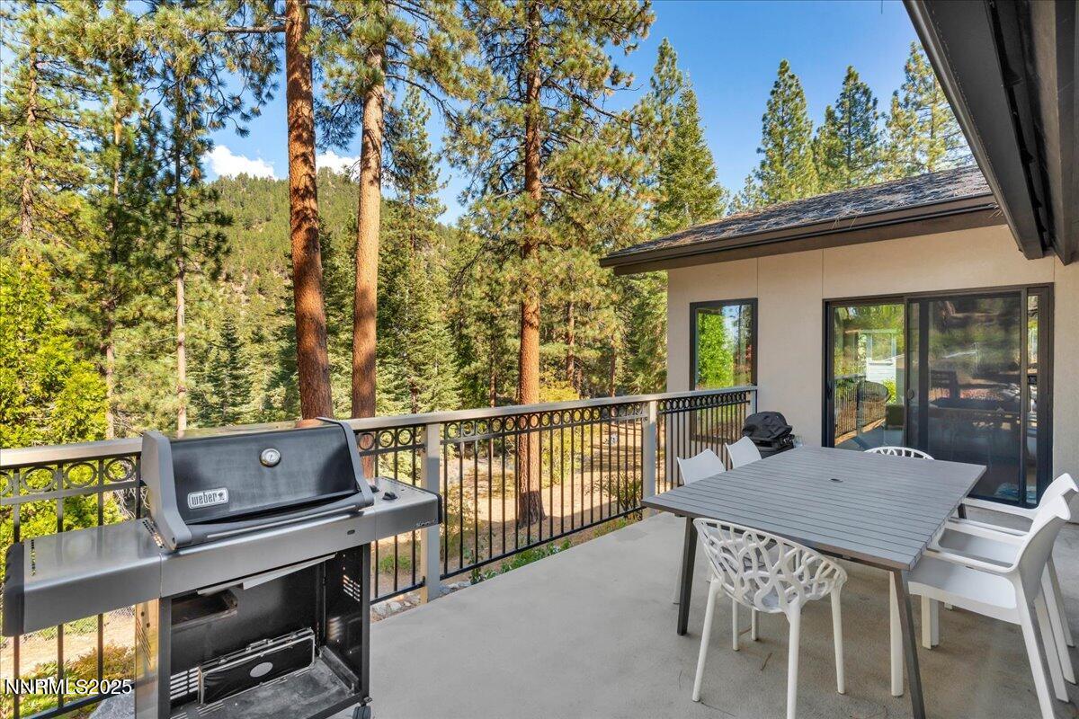 1262 Hidden Woods Drive Zephyr Cove, NV 89448 - Photo 68 of 81 a view of a deck with table and chairs with wooden floor and fence