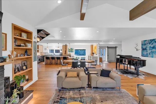 a living room with furniture potted plant and a large window