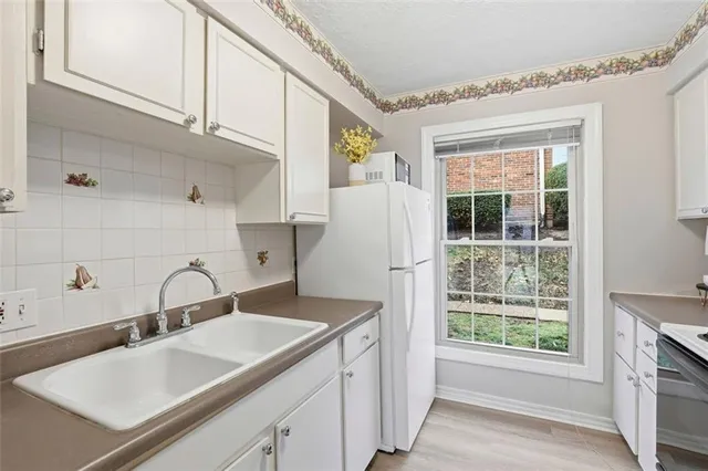 a kitchen with a sink and a refrigerator