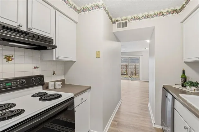 a kitchen with a stove and cabinets