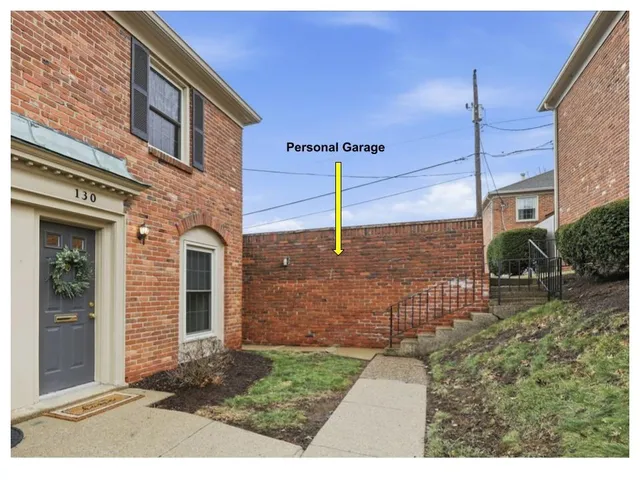 a view of a brick house with a yard