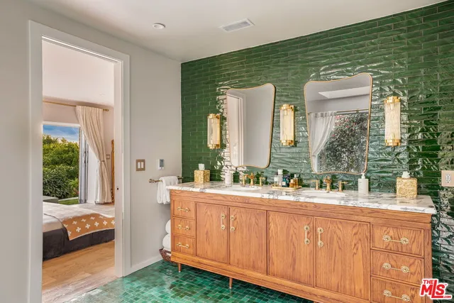 a bathroom with a double vanity sink and a mirror