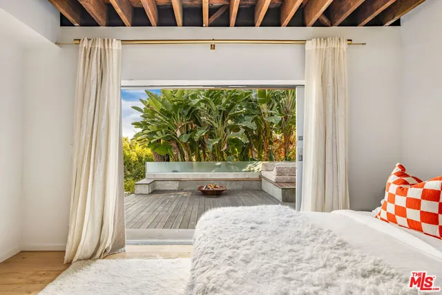 a bedroom with a large bed and a couch