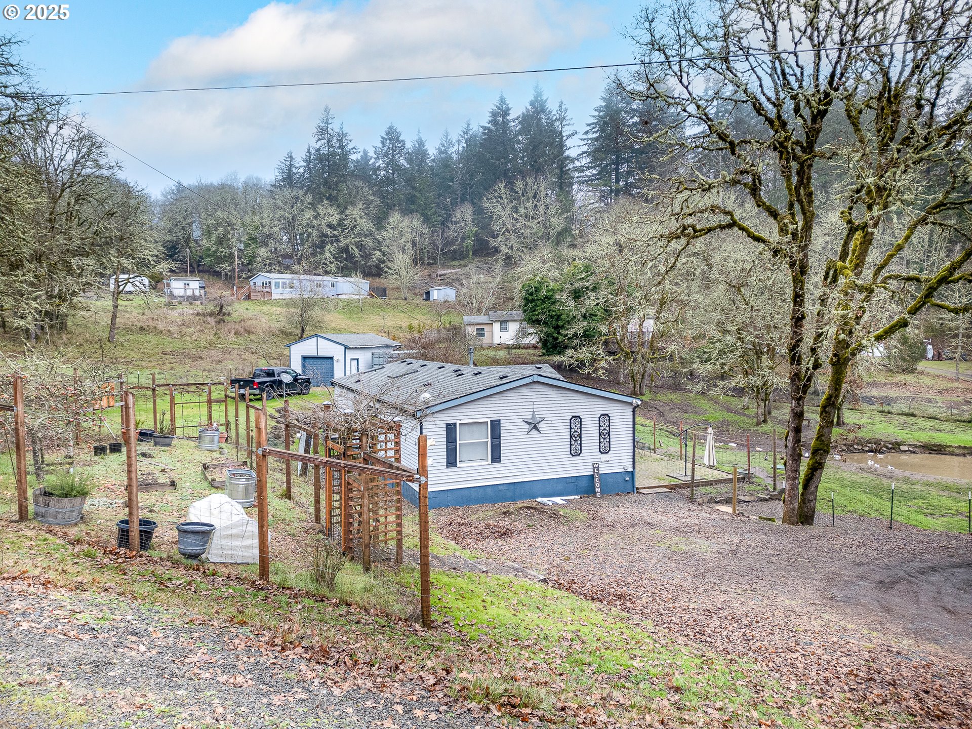32437 Hidden Valley Road Lebanon, OR 97355 - Photo 3 of 29 a view of a house with a yard and sitting area