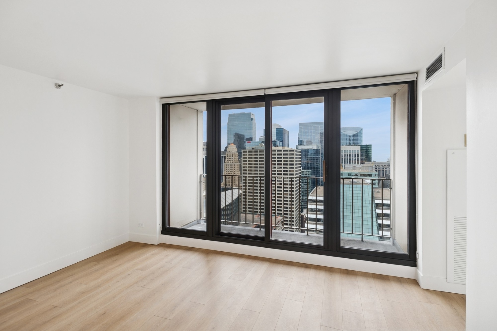 200 North Dearborn Street, Unit 4301 Chicago, IL 60601 - Photo 9 of 21 an empty room with wooden floor and windows