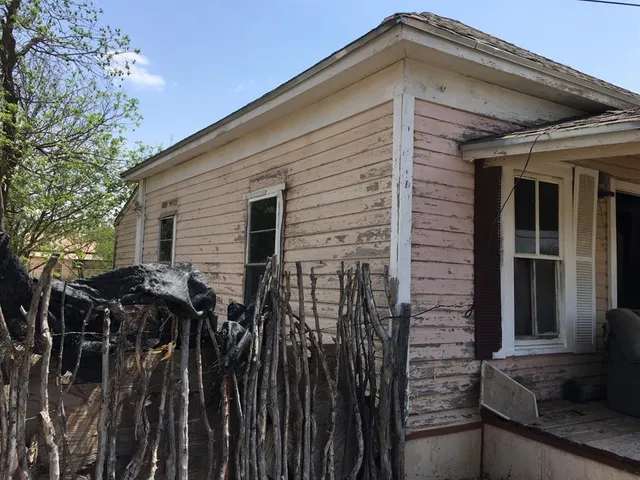 a view of a house with wooden fence
