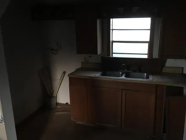a bathroom with a sink a window and a mirror