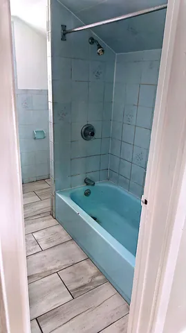 a white toilet sitting next to a shower