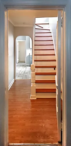 a view of a staircase with white walls and a rug