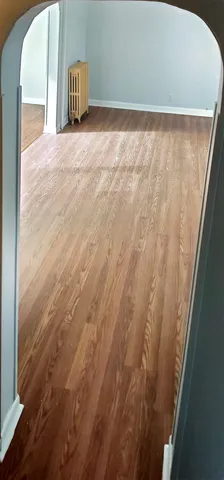 a view of a room with an empty space and a window