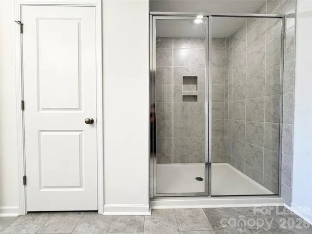 a bathroom with a glass shower door