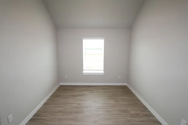 a view of a room with wooden floor and window