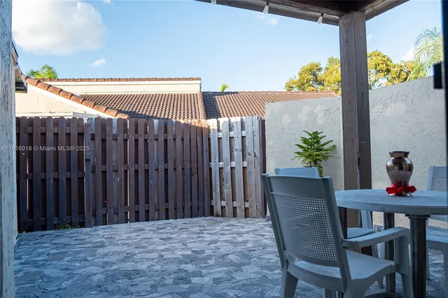 a view of a chairs and table in the patio