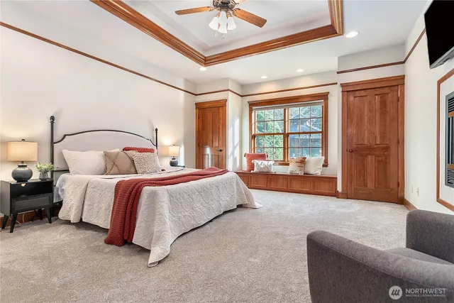 a bedroom with bed and a large window with outer view