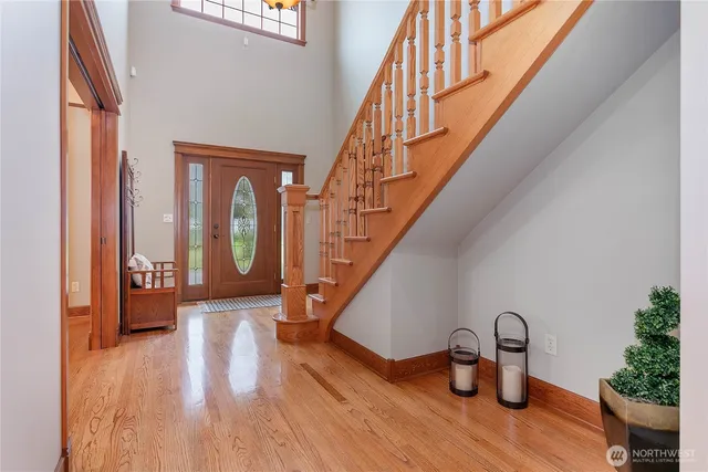 a view of entryway and hall with wooden floor