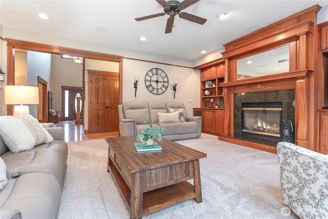 a living room with furniture a window and a fireplace