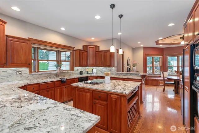a kitchen with a stove sink and wooden cabinets