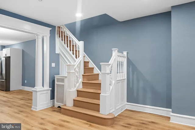 a view of entryway and hall with wooden floor