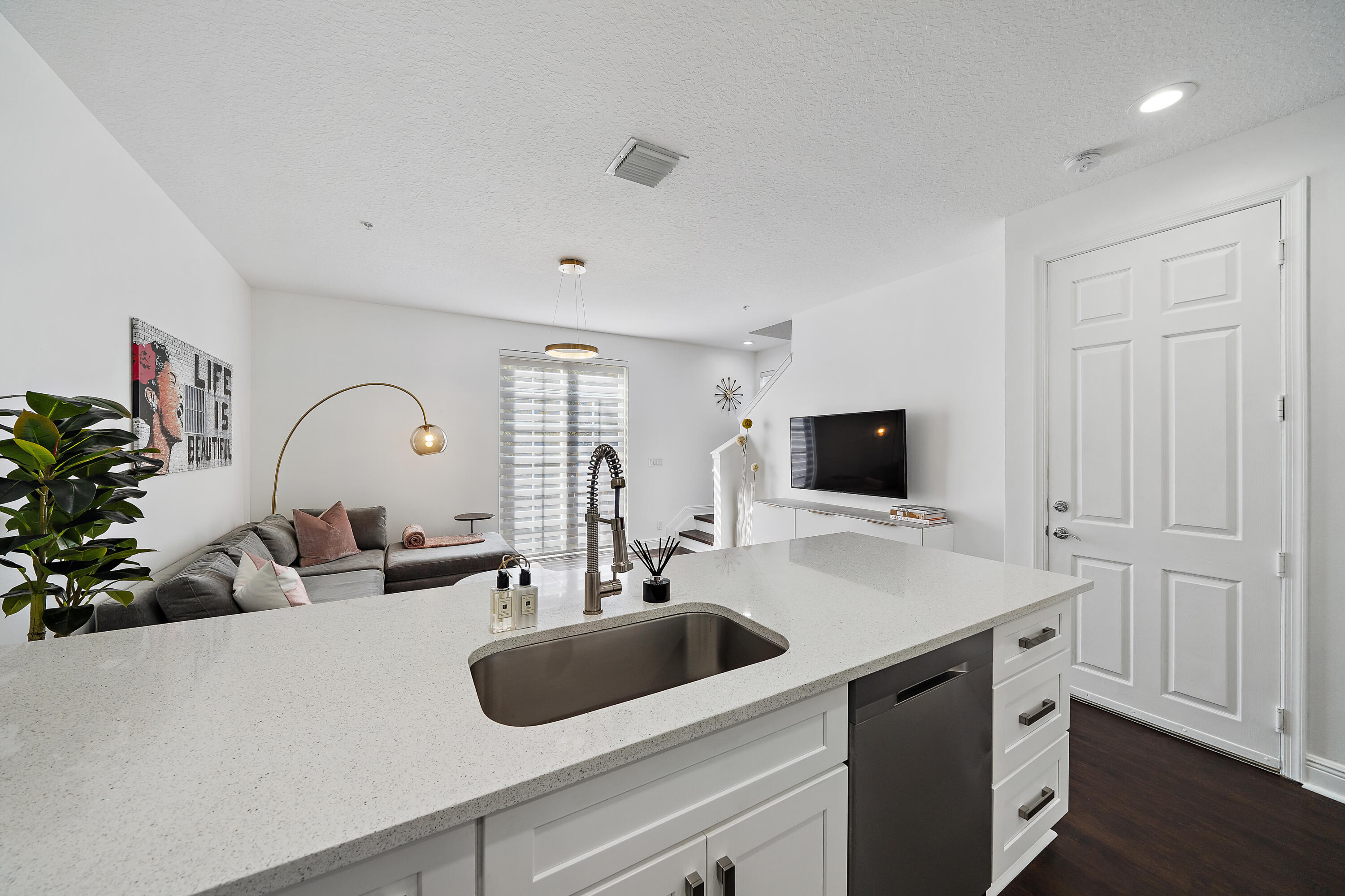 113 West Indian Crossing Circle Jupiter, FL 33458 - Photo 12 of 38 a sink with a large mirror and cabinets