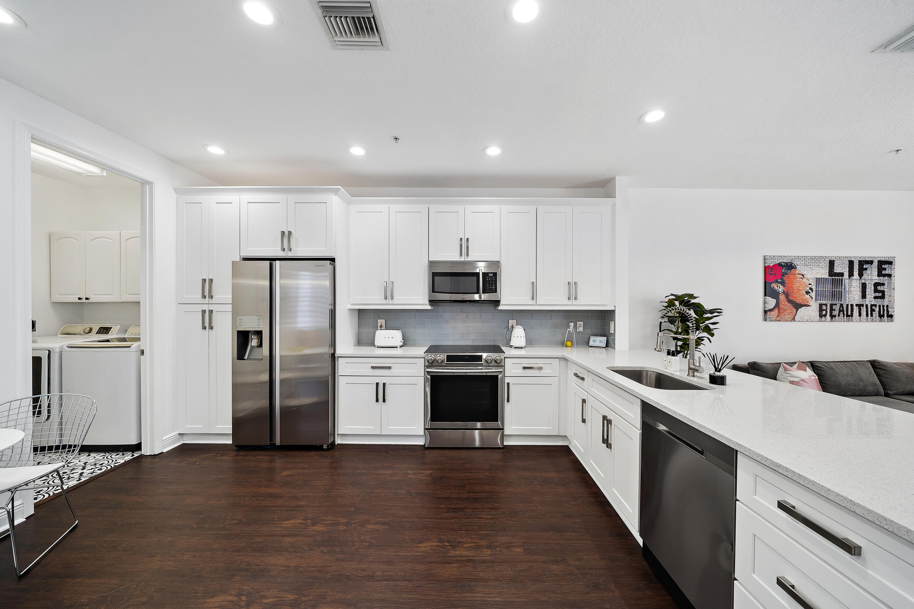 113 West Indian Crossing Circle Jupiter, FL 33458 - Photo 14 of 38 a kitchen with refrigerator a sink and cabinets