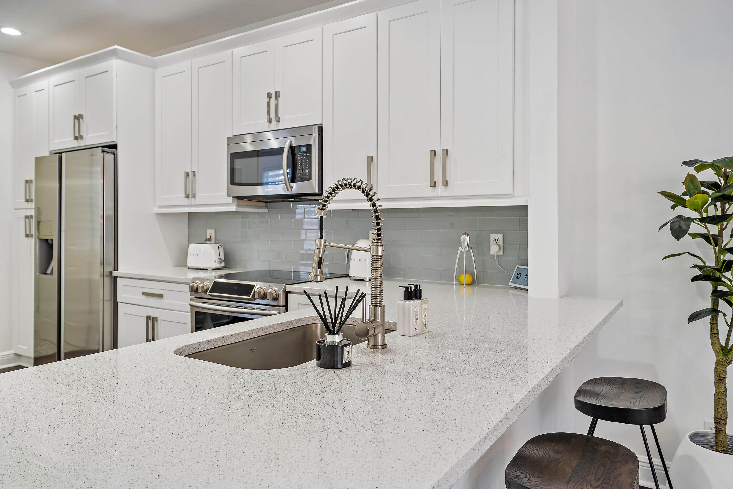 113 West Indian Crossing Circle Jupiter, FL 33458 - Photo 15 of 38 a kitchen with stainless steel appliances granite countertop a stove a refrigerator and a sink