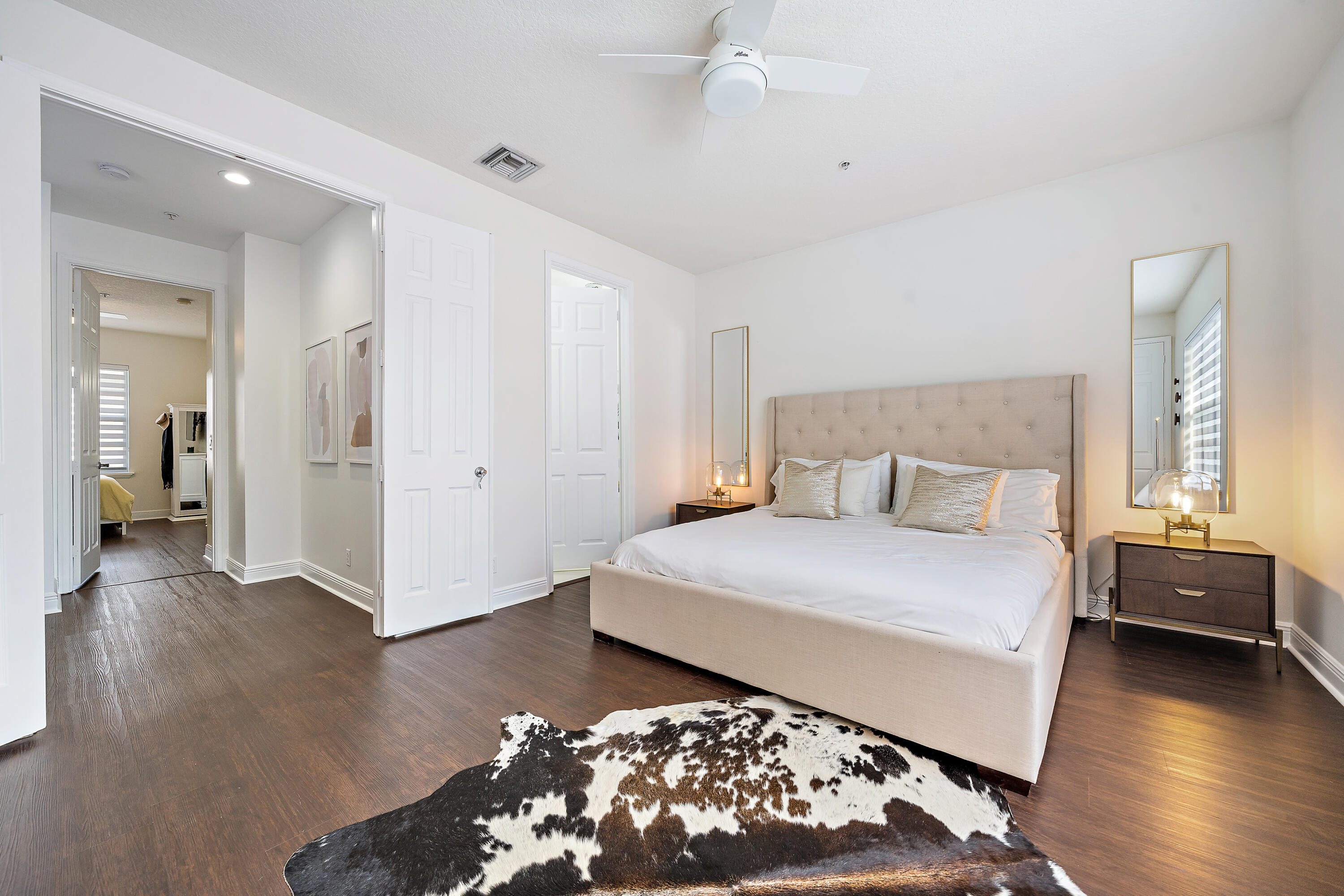 113 West Indian Crossing Circle Jupiter, FL 33458 - Photo 26 of 38 a bedroom with a large bed and a chandelier