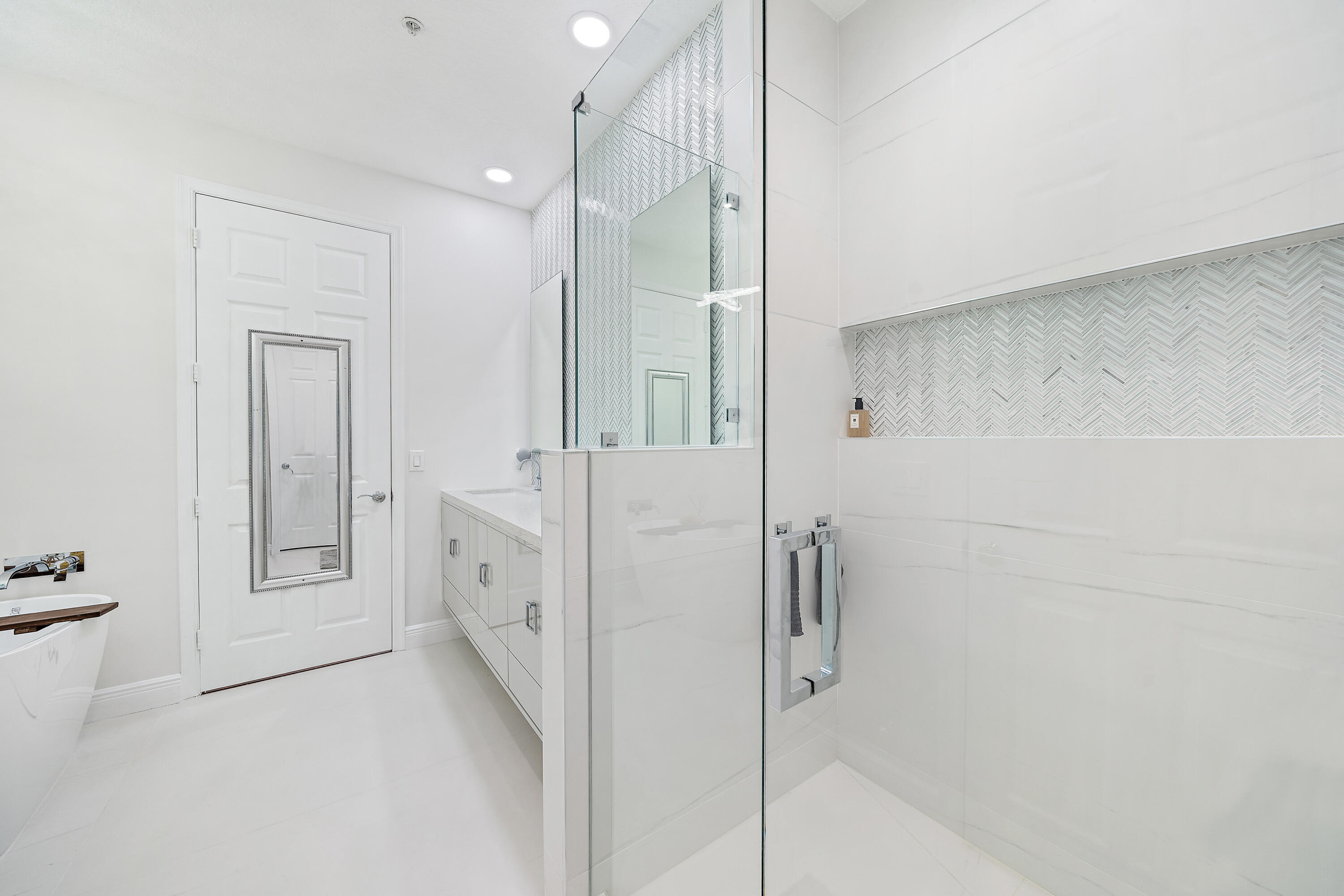 113 West Indian Crossing Circle Jupiter, FL 33458 - Photo 31 of 38 a bathroom with a double vanity sink and shower