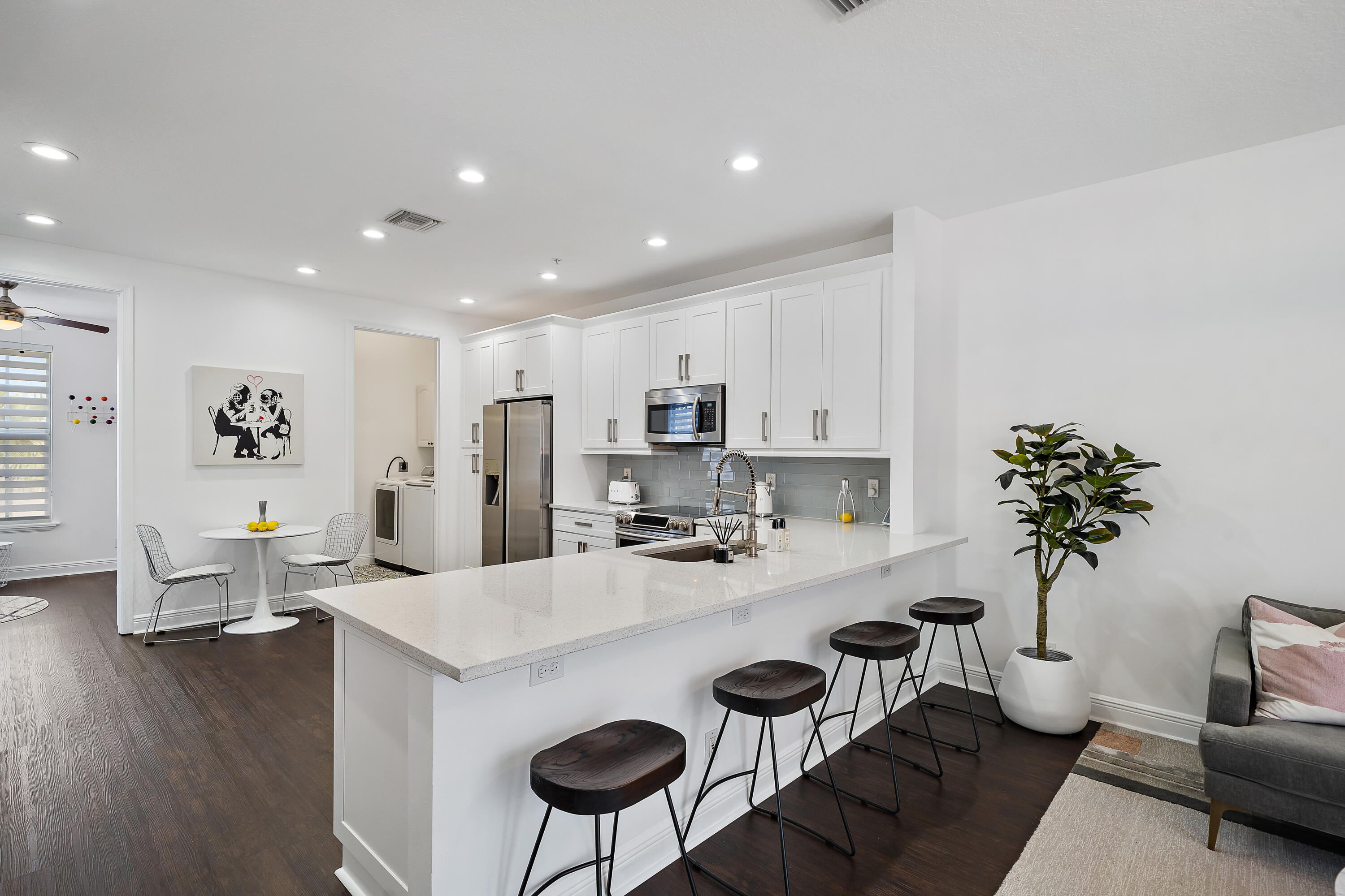 113 West Indian Crossing Circle Jupiter, FL 33458 - Photo 10 of 38 a kitchen with furniture and a refrigerator