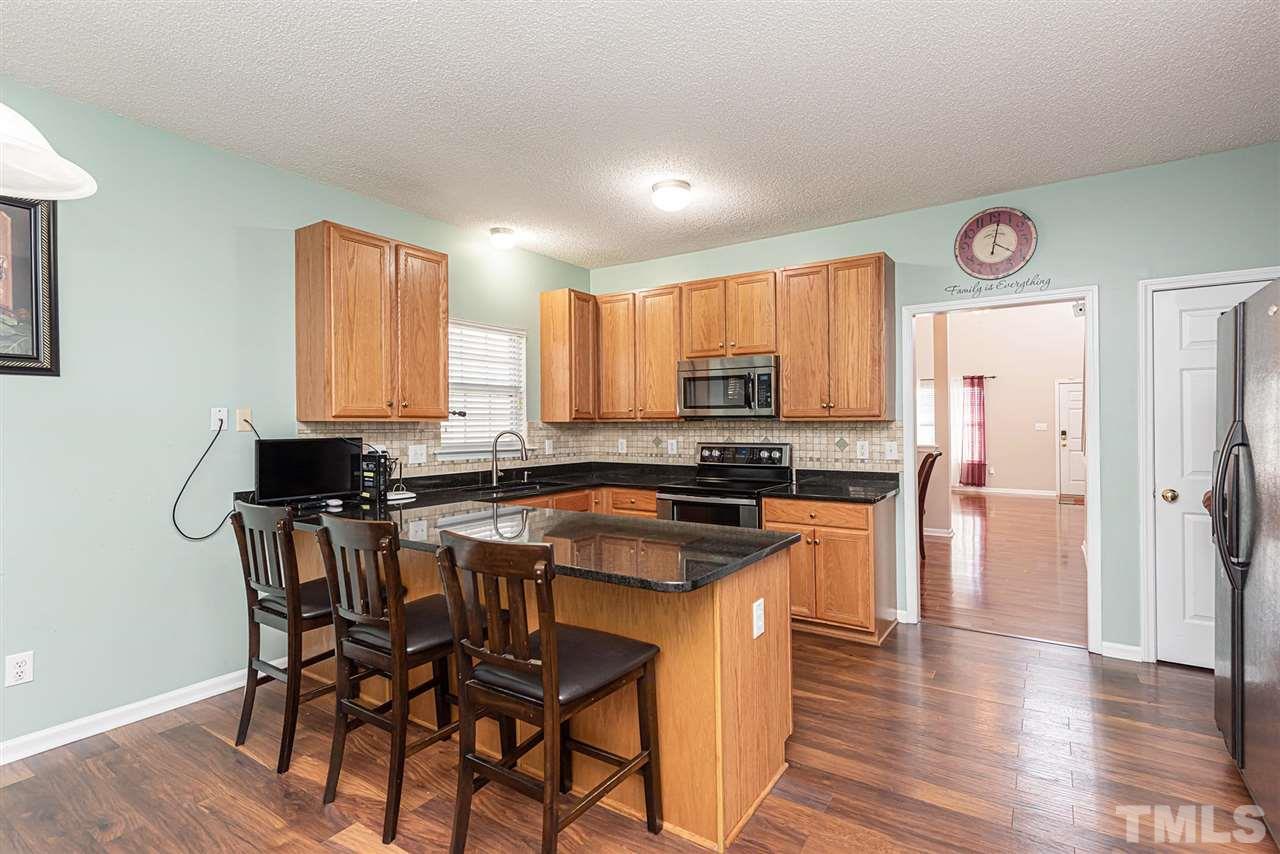 6839 Paint Rock Lane Raleigh, NC 27610 - Photo 5 of 22 Kitchen w/breakfast bar. Enough room for an eat-in kitchen table.