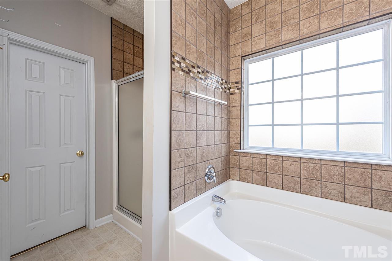 6839 Paint Rock Lane Raleigh, NC 27610 - Photo 10 of 22 Master bath down with separate soaking tub and separate shower.