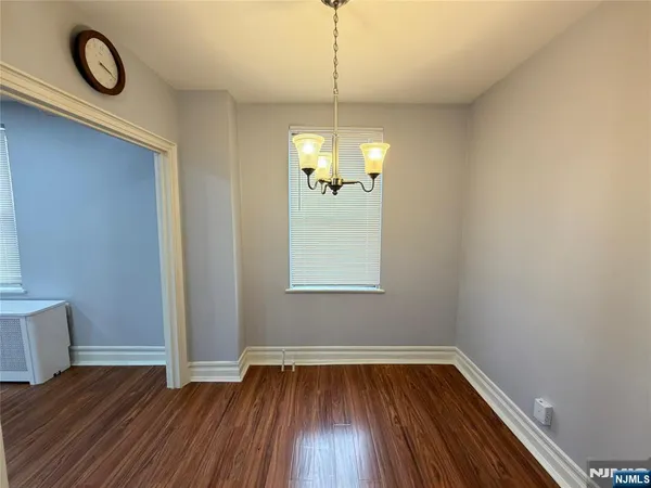 a view of a room with wooden floor and window