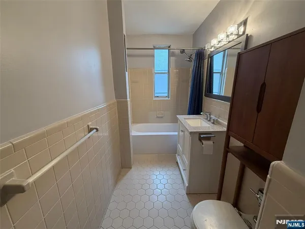 a bathroom with sink toilet and shower