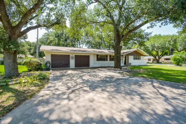 a front view of house with yard and green space