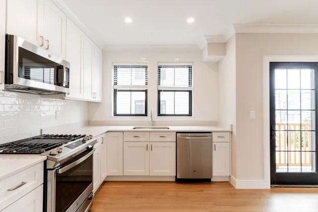 a kitchen with stainless steel appliances granite countertop a stove and a sink