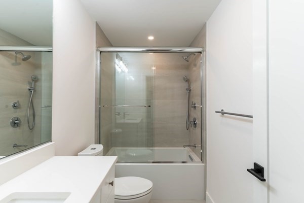 285 Lamartine Street, Unit 2 Boston, MA 02130 - Photo 7 of 13 a bathroom with a bathtub shower sink vanity and toilet