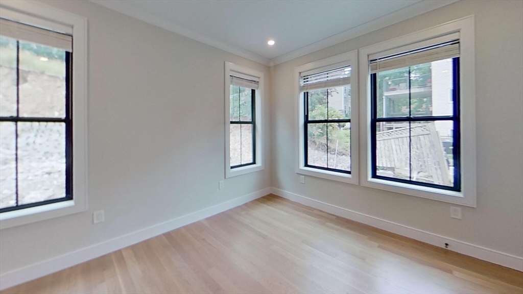 285 Lamartine Street, Unit 2 Boston, MA 02130 - Photo 10 of 13 an empty room with windows and closet
