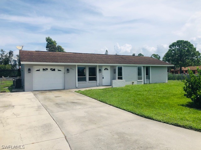 18577 Iris Road Fort Myers, FL 33967 - Photo 1 of 16 front view of a house with a yard and a garage