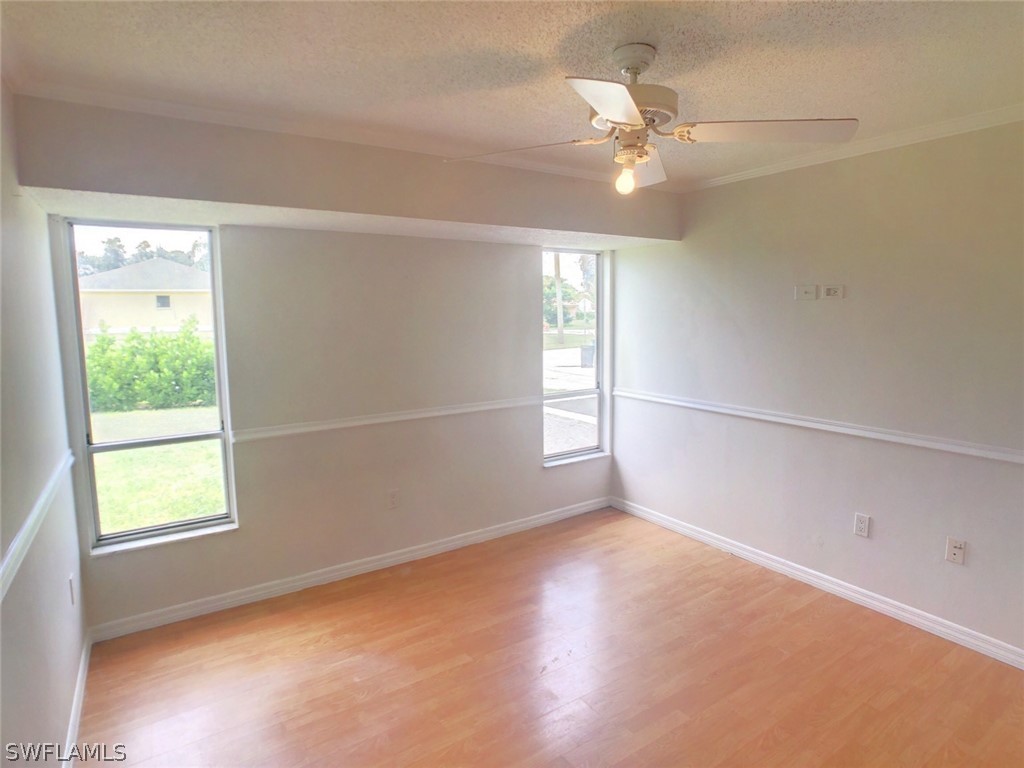 18577 Iris Road Fort Myers, FL 33967 - Photo 11 of 16 wooden floor in an empty room with a window