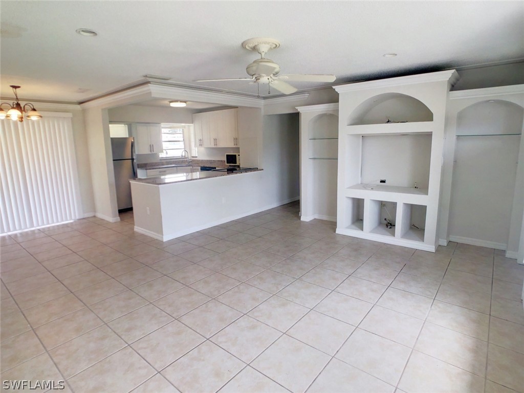 18577 Iris Road Fort Myers, FL 33967 - Photo 12 of 16 a large kitchen with kitchen island a large counter space and appliances
