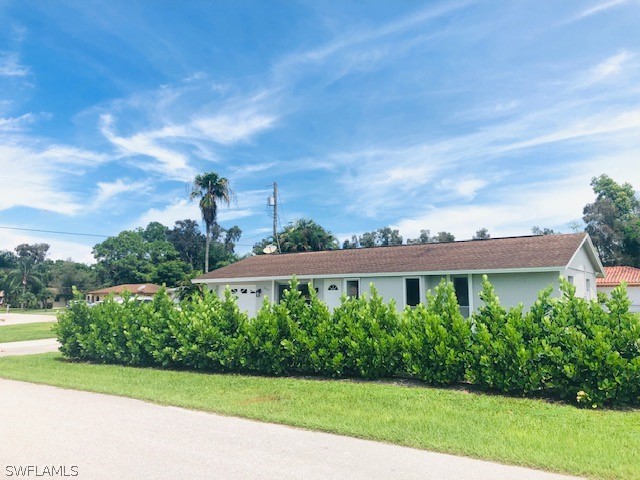 18577 Iris Road Fort Myers, FL 33967 - Photo 16 of 16 a view of a garden with a building in the background