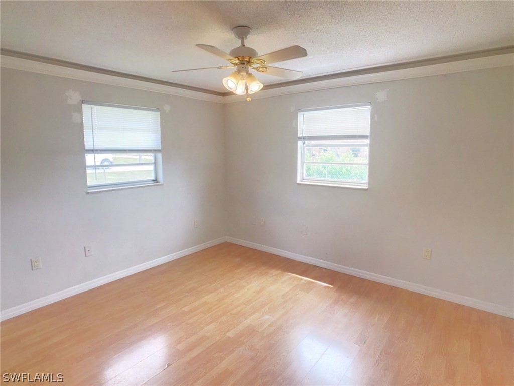 18577 Iris Road Fort Myers, FL 33967 - Photo 7 of 16 an empty room with a window and a fan