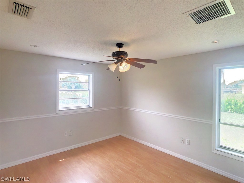 18577 Iris Road Fort Myers, FL 33967 - Photo 10 of 16 an empty room with windows and fan