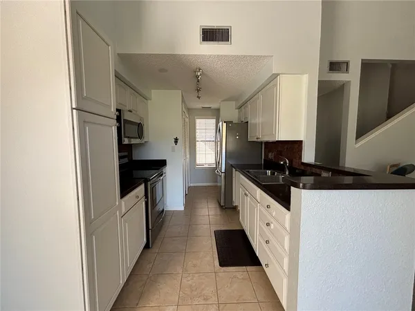 a large kitchen with a stove top oven