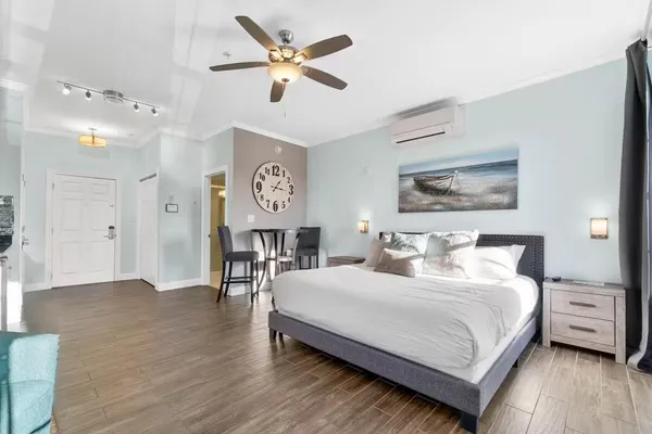 a bedroom with a bed chandelier and a window