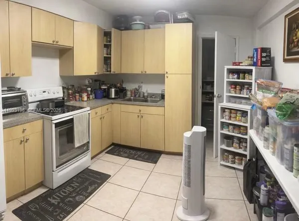 a kitchen with a cabinets and appliances