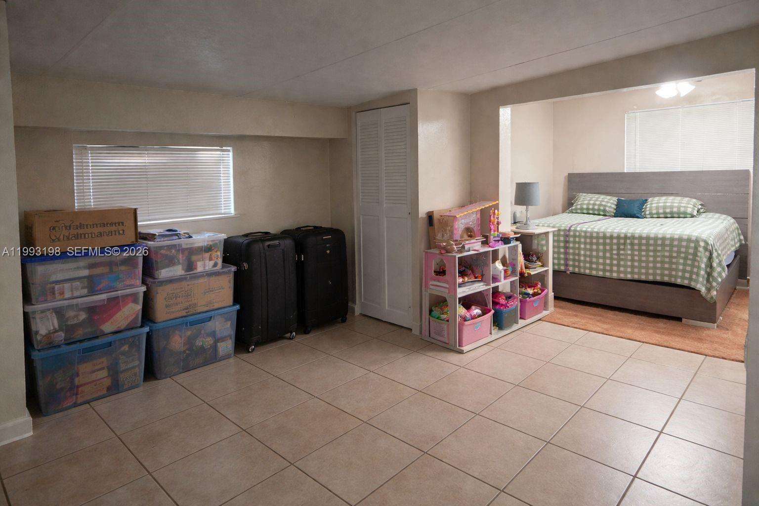 2353 Southwest 2nd Street Miami, FL 33135 - Photo 3 of 7 a bedroom with a bed and a window