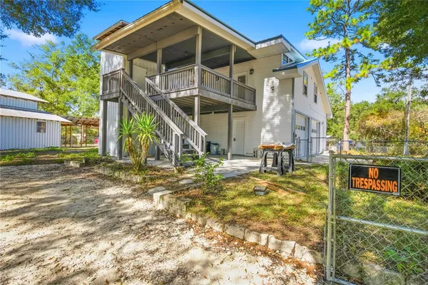 a view of a house with yard and sitting area