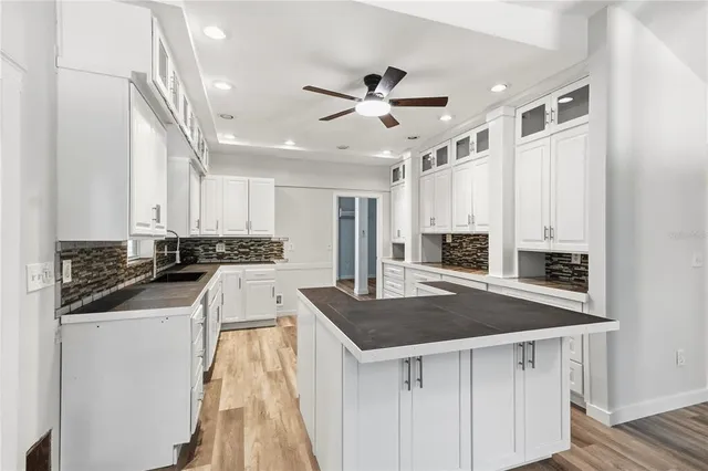 a kitchen with stainless steel appliances granite countertop a sink and a stove