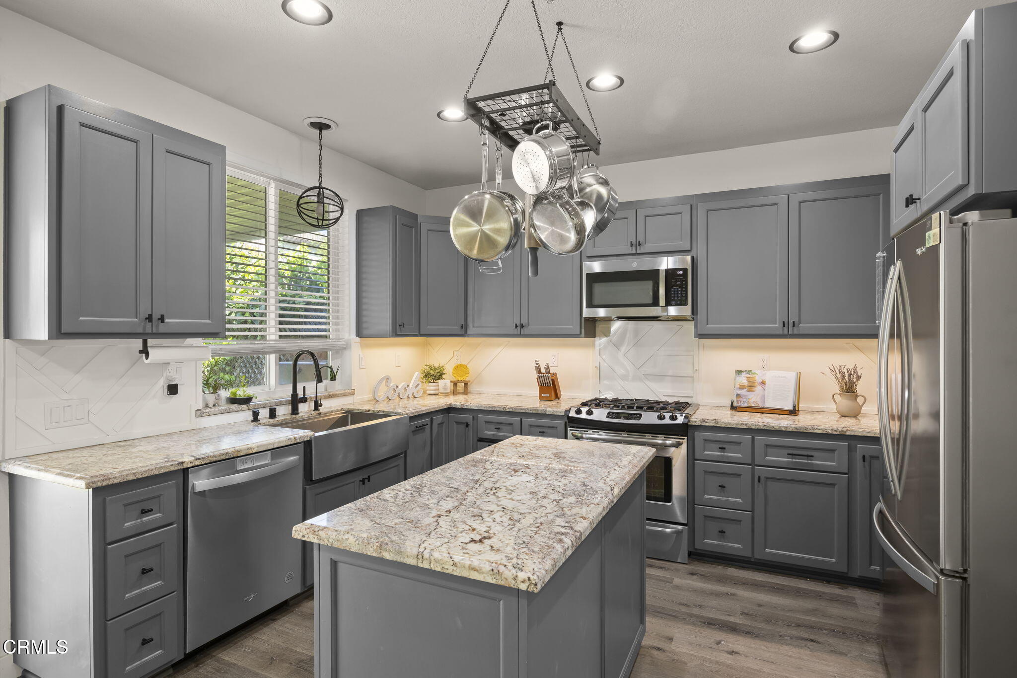 803 Noontide Way Oxnard, CA 93035 - Photo 11 of 44 a kitchen with a sink stove and microwave